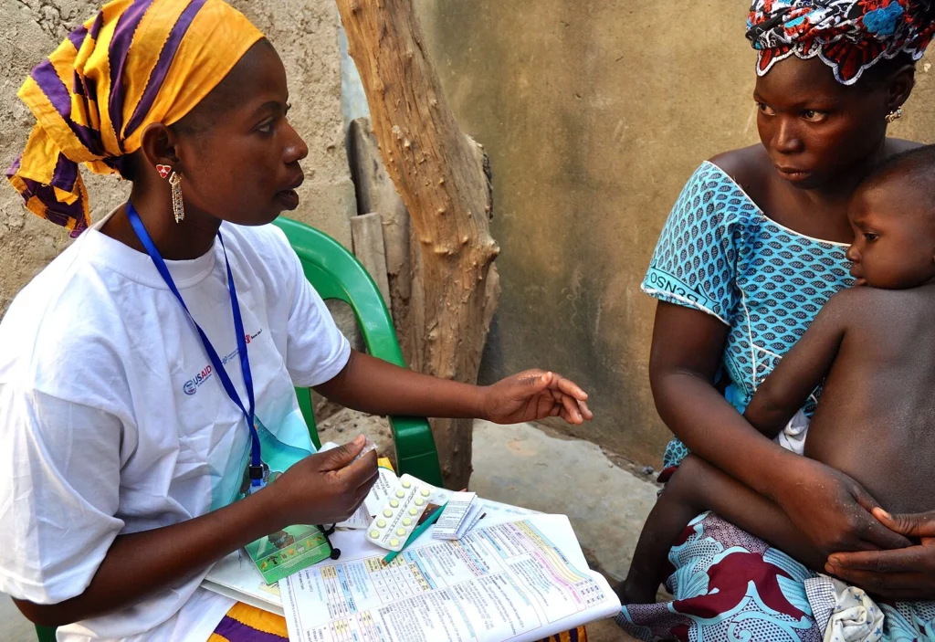 Community Health Worker treats child