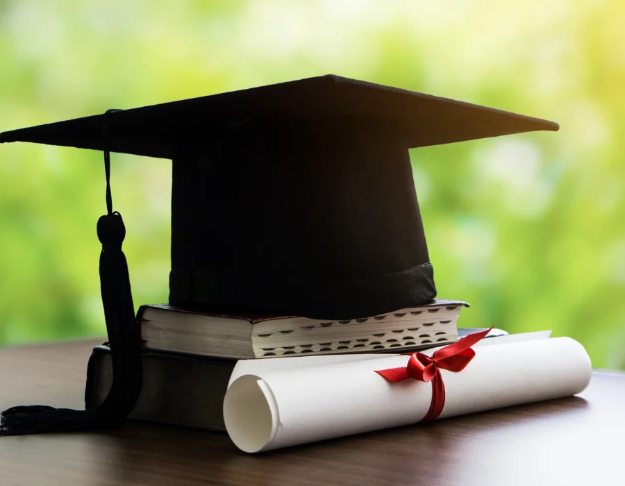mortar-board-with-degree-paper-and-books-on-wood-t-2024-12-02-06-58-02-utc